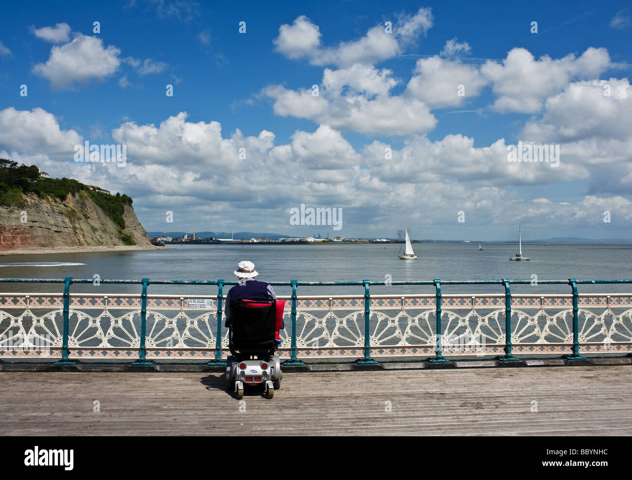 A disabled person in a wheelchair on Penarth Pier in South Wales.  Photo by Gordon Scammell Stock Photo