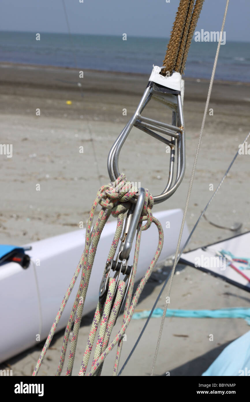 Trapeze ropes with pulley block from a sail boat on a beach Stock Photo Alamy
