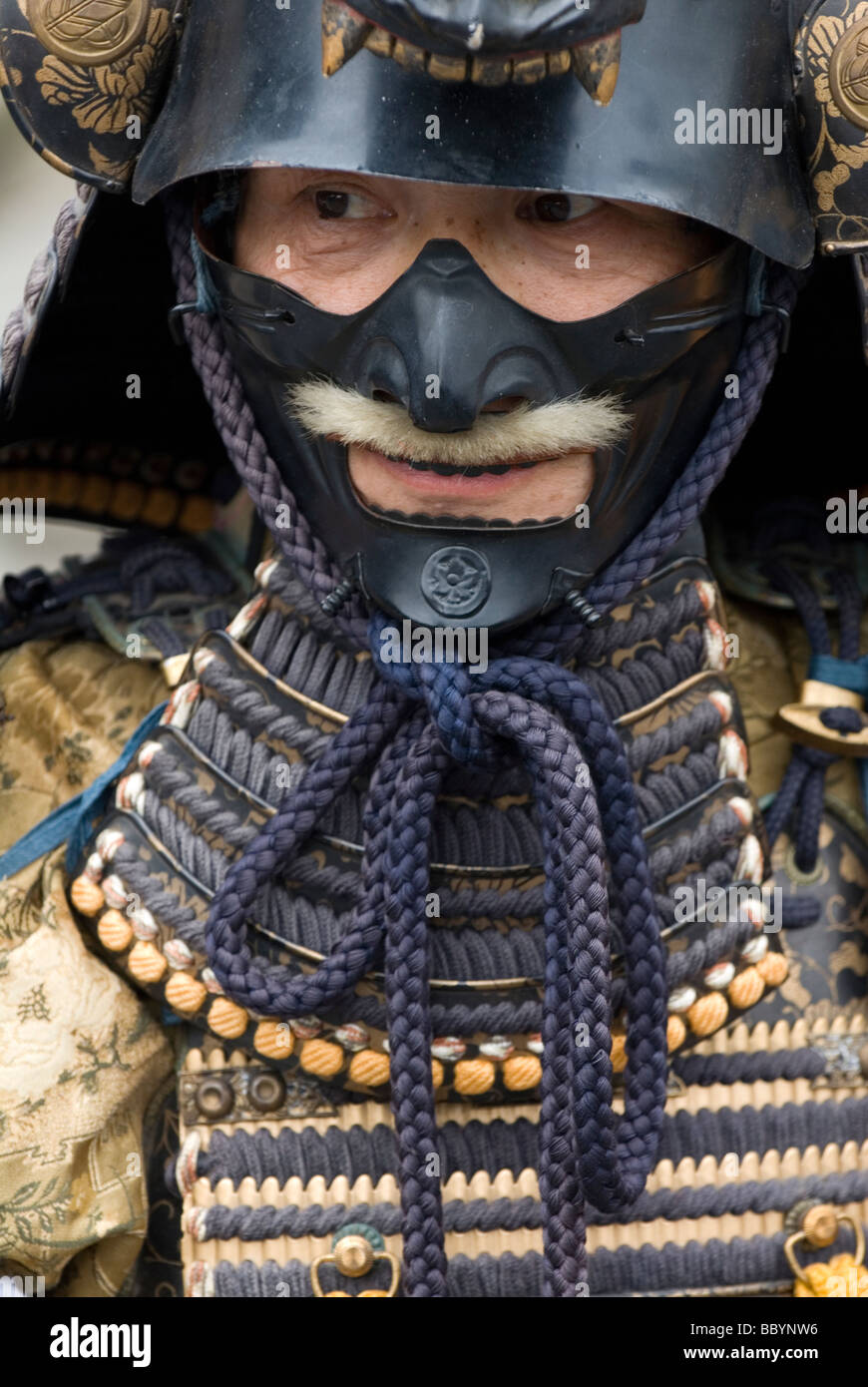Man dressed in full samurai armor complete with kabuto helmet and mempo face mask to intimidate the enemy Stock Photo