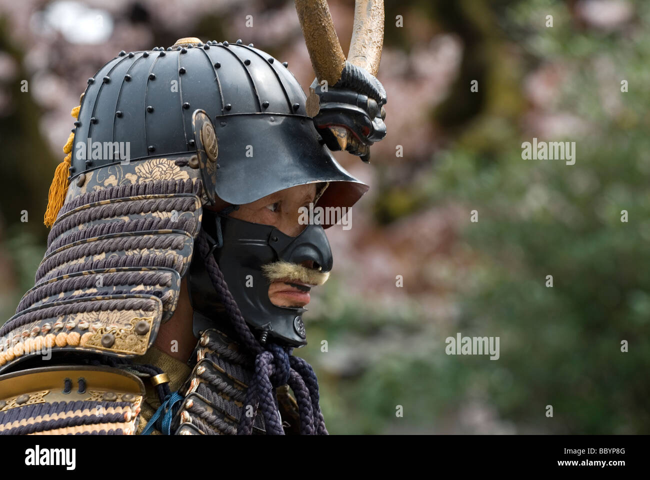 Man dressed in full samurai armor complete with kabuto helmet and mempo face mask to intimidate the enemy Stock Photo