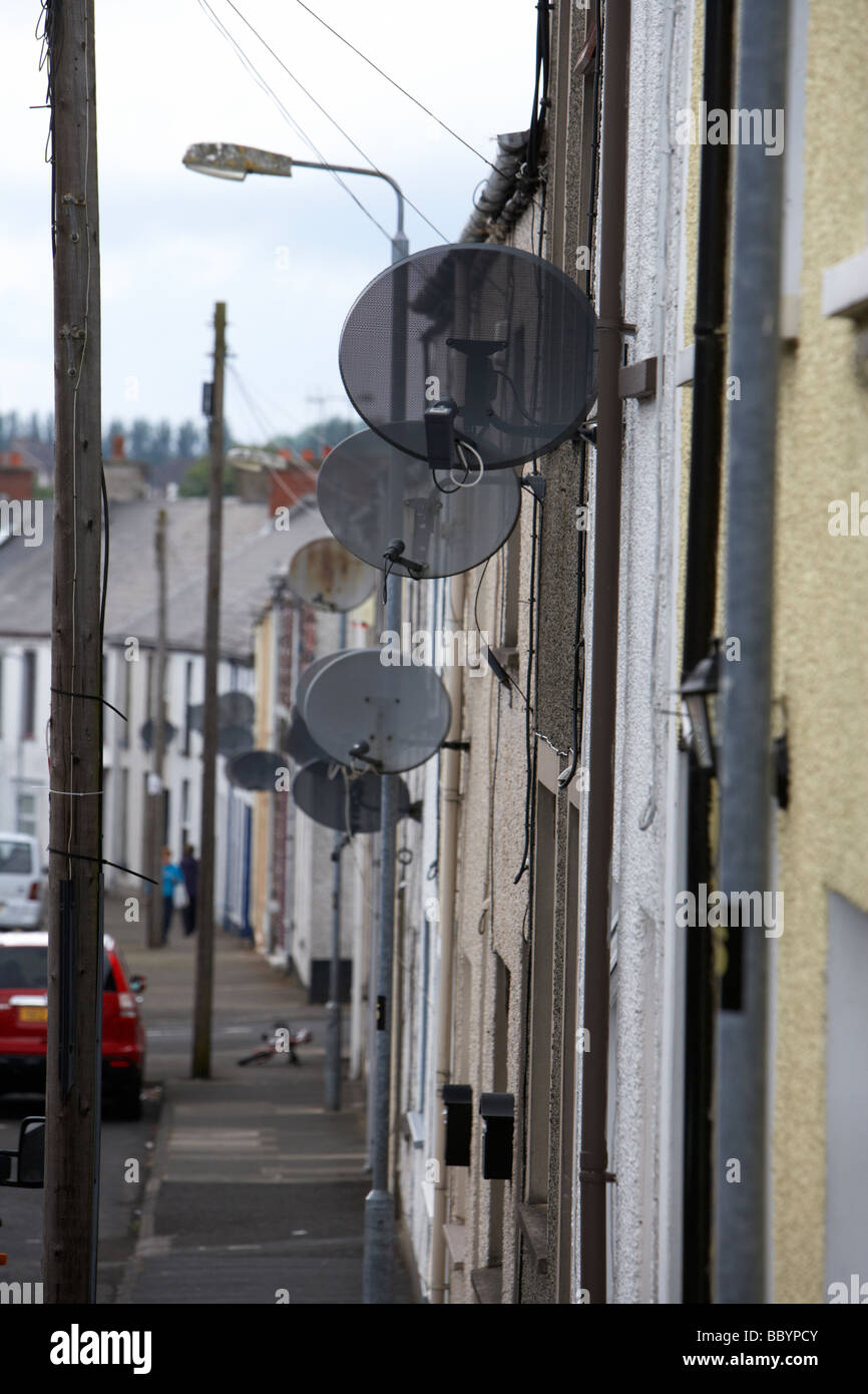 rows of tv satellite dishes on 2 up two down social housing terraced in