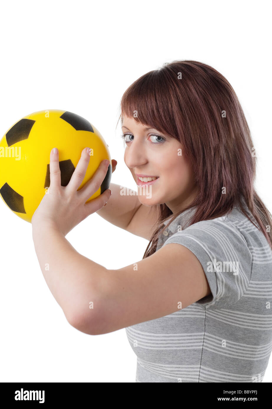 Teenager girl throwing yellow ball isolated on white Stock Photo Alamy