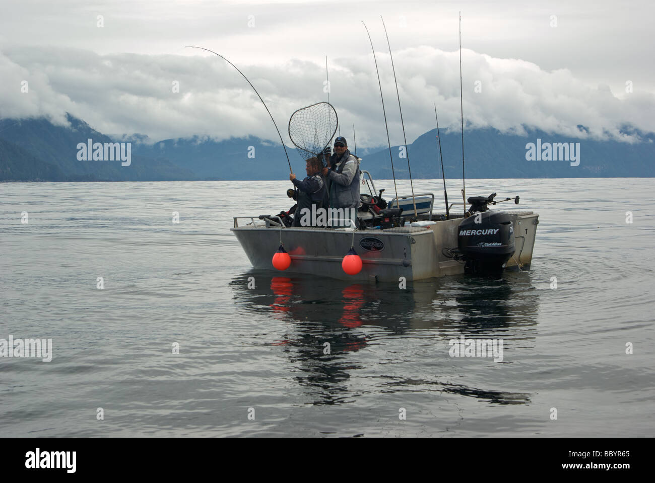 Male angler battling chinook salmon at Freeman Rocks on west coast