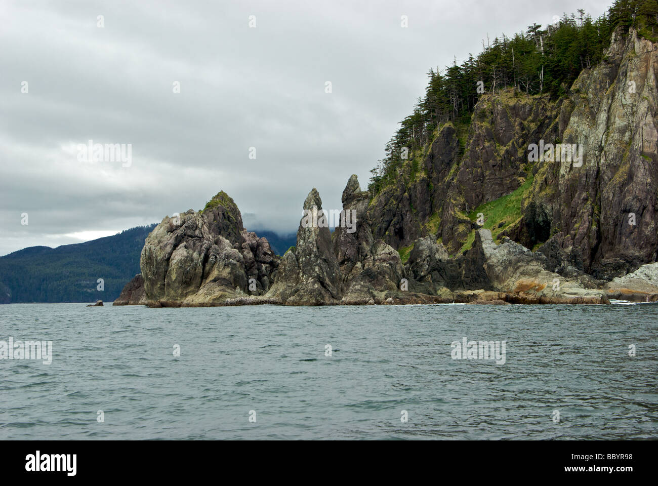 Rugged weather and sea scarred rock pinnacles at Skelu Point in Haida Gwaii Stock Photo