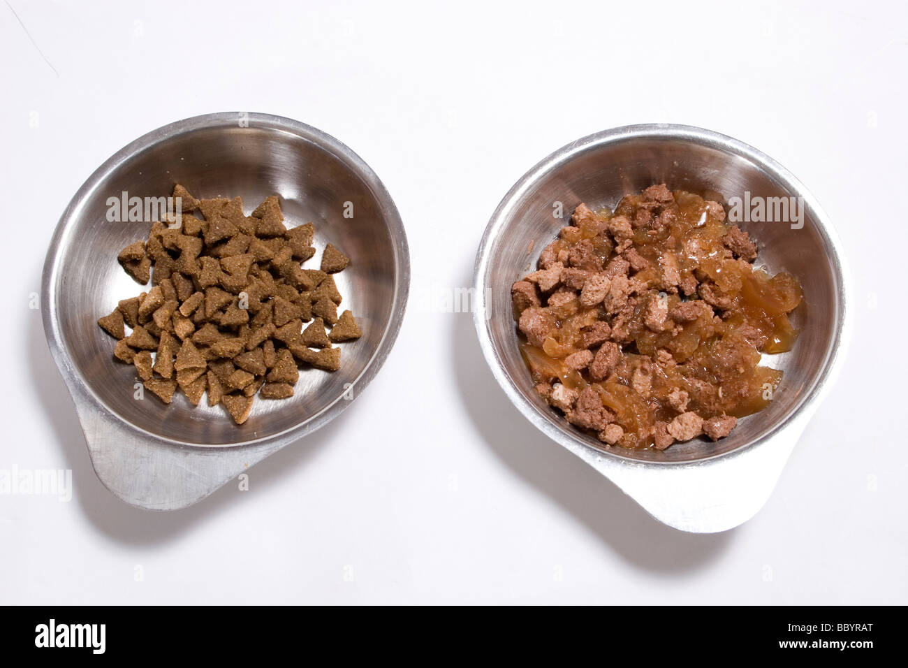 two bowls containing dry and wet cat food Stock Photo