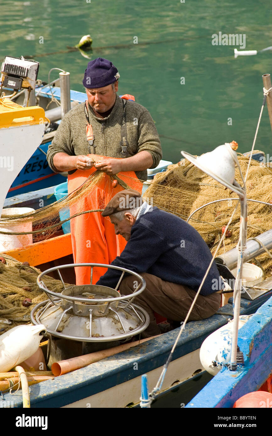 Fishermen and fishing boat at harbor Castellammare del Golfo, Sicily, Italy, Europe Stock Photo