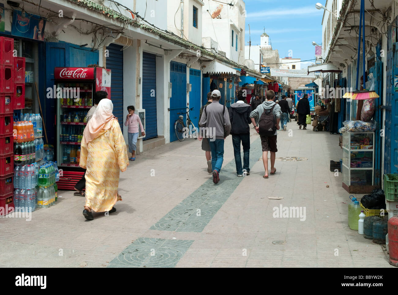 Traditionally dressed women and tourists in the city, Essaouira, Morocco, Africa Stock Photo