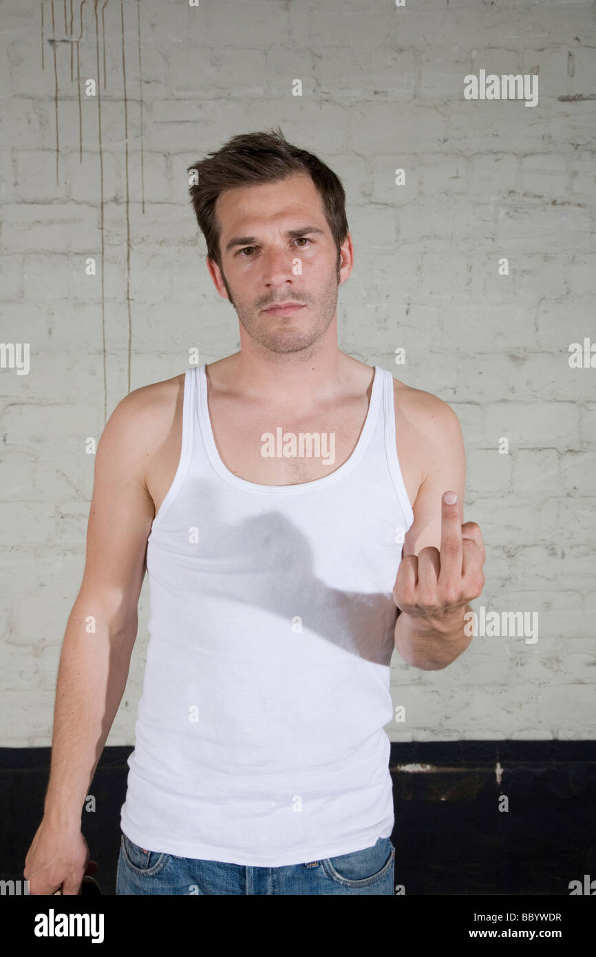 Annoyed young man, showing the middle finger Stock Photo