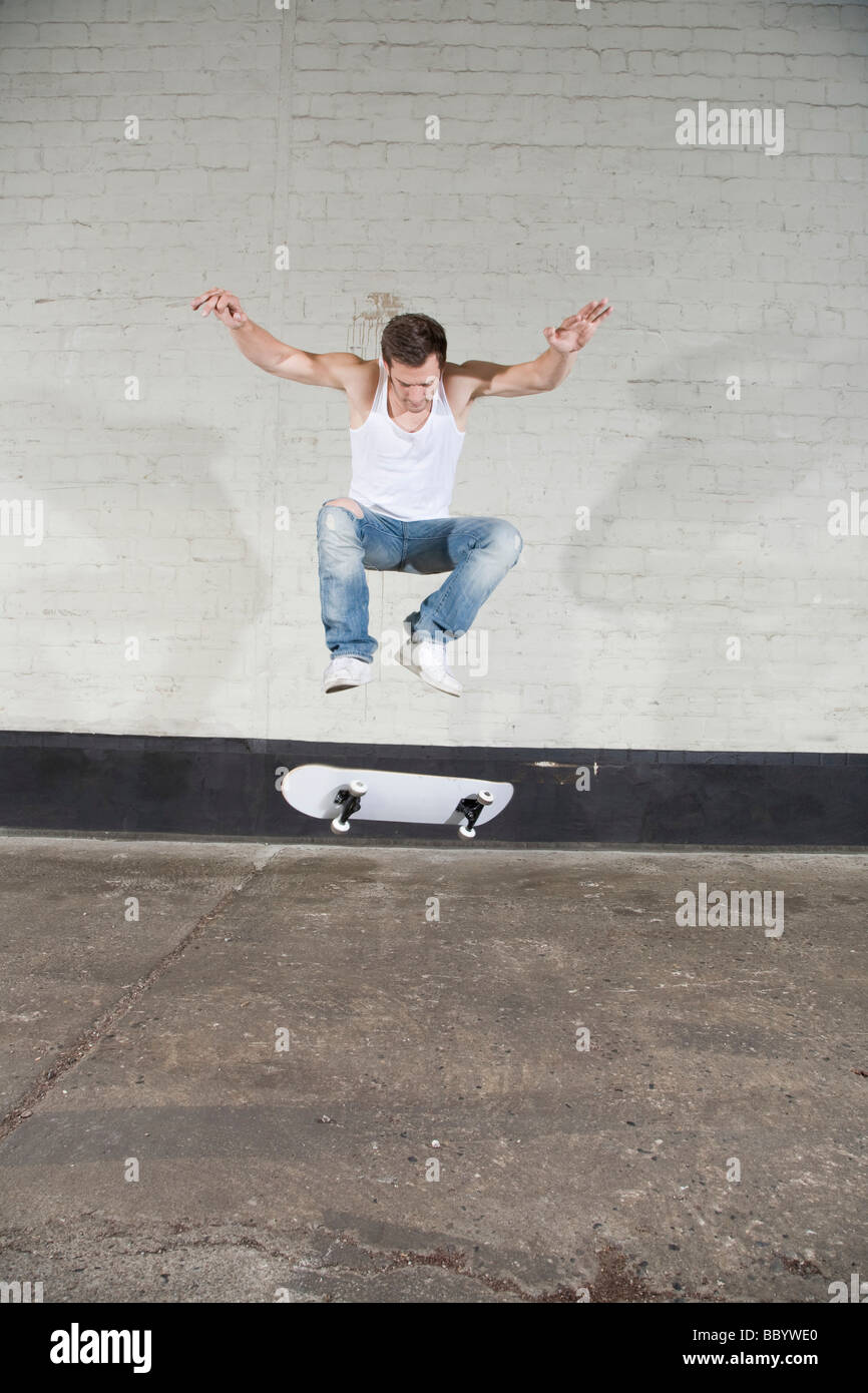 Skateboarder doing a flip trick Stock Photo