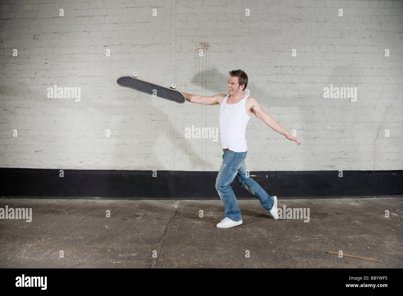 Angry skateboarder chucking his board Stock Photo
