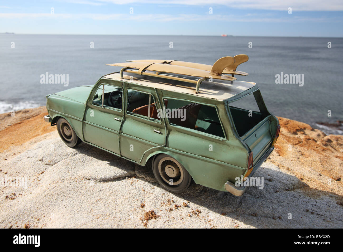 BEATEN UP OLD MODEL STATION WAGON WITH SURFBOARDS ON TOP BDB11230 HORIZONTAL Stock Photo