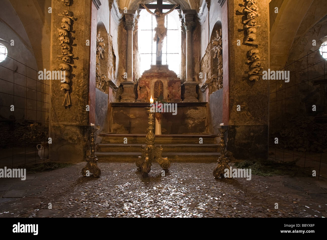 Altar in old church ossuary with human skulls and bones on walls Kutna Hora Czech Republic Stock Photo