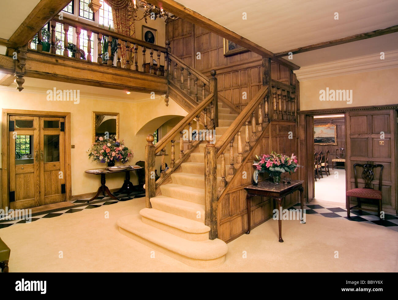 England, Country House Reception Hall with oak panelled walls and grand