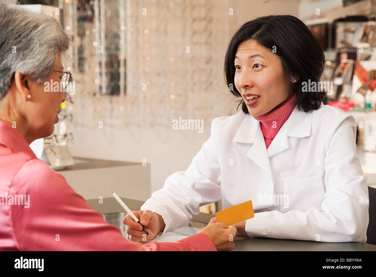Korean optician talking to customer Stock Photo