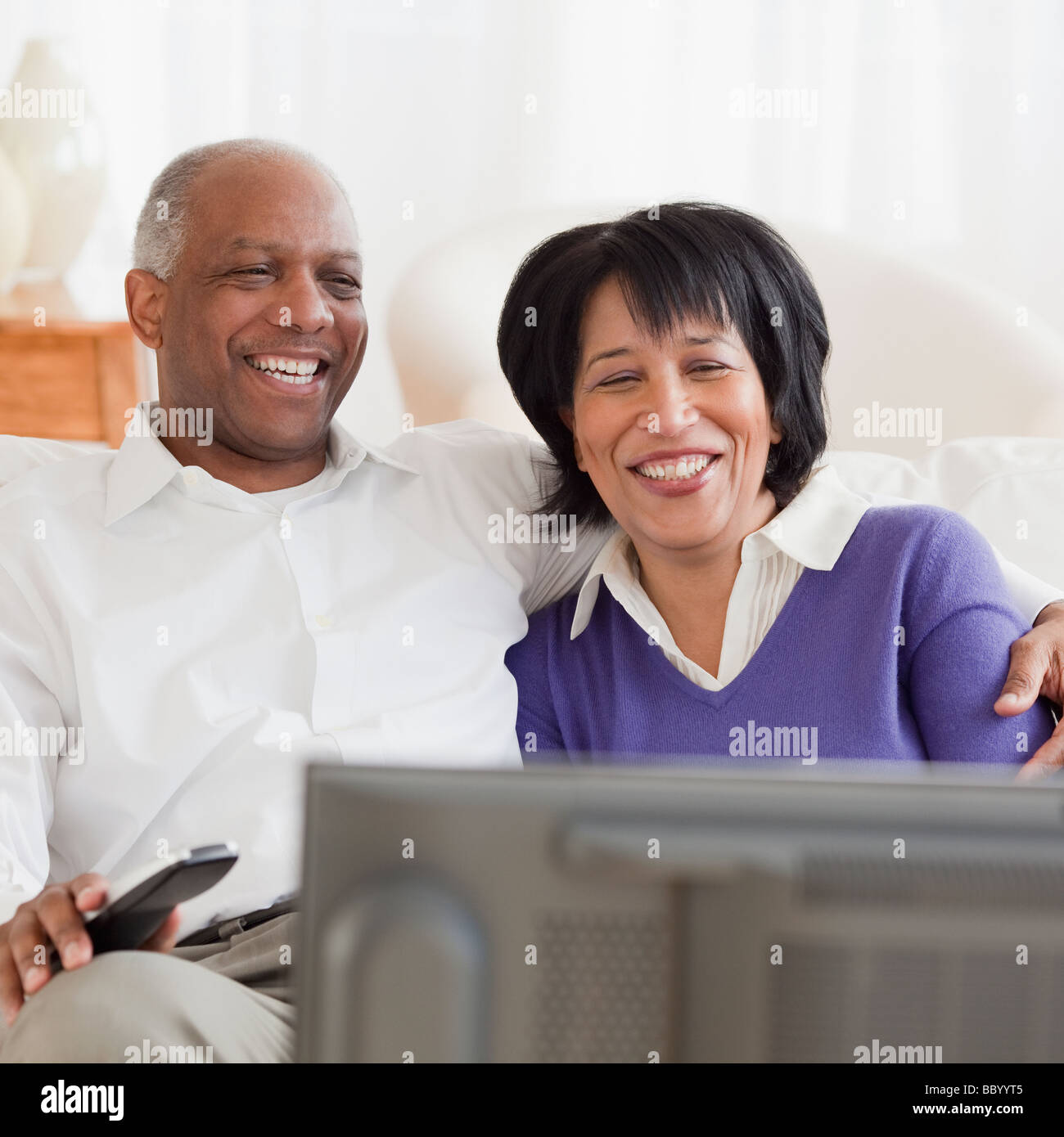 African couple watching television Stock Photo