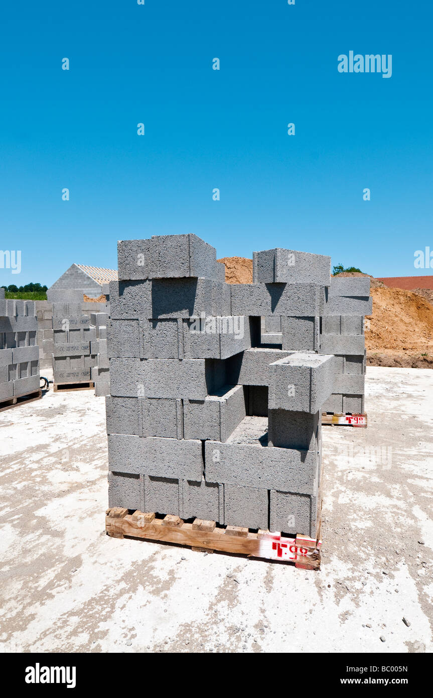 Stacks of breeze block building materials on new housing estate 