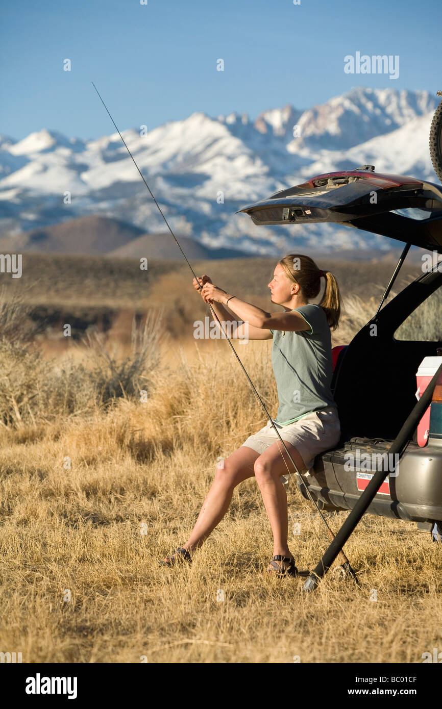 Young woman gets ready to go fly fishing in CA Stock Photo Alamy