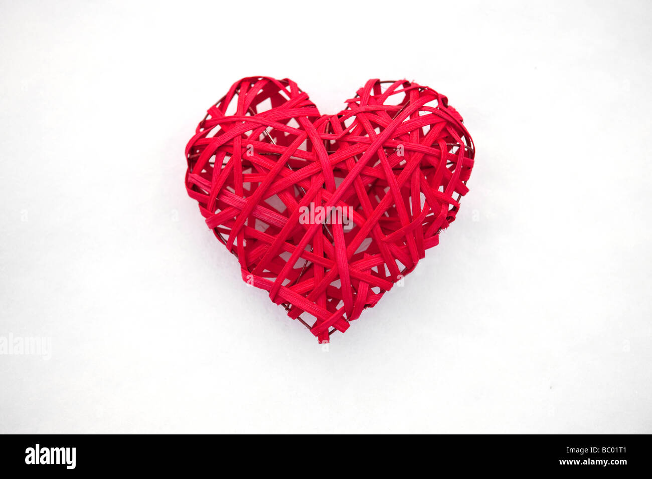 Red Valentine heart on white snow Stock Photo