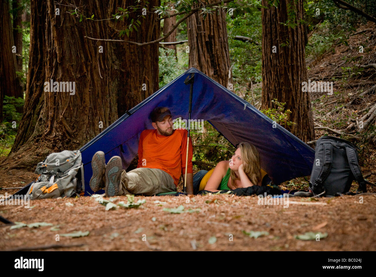 A young couple camping in the redwood forests of Big Sur. Stock Photo