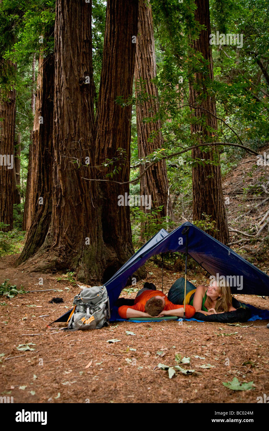 A young couple camping in the redwood forests of Big Sur. Stock Photo