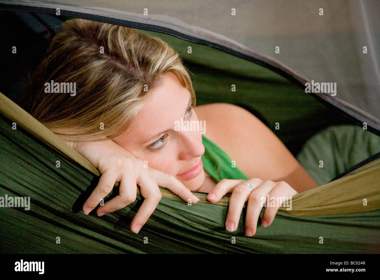 A woman in a hammock while camping in the redwood forests of Big Sur. Stock Photo