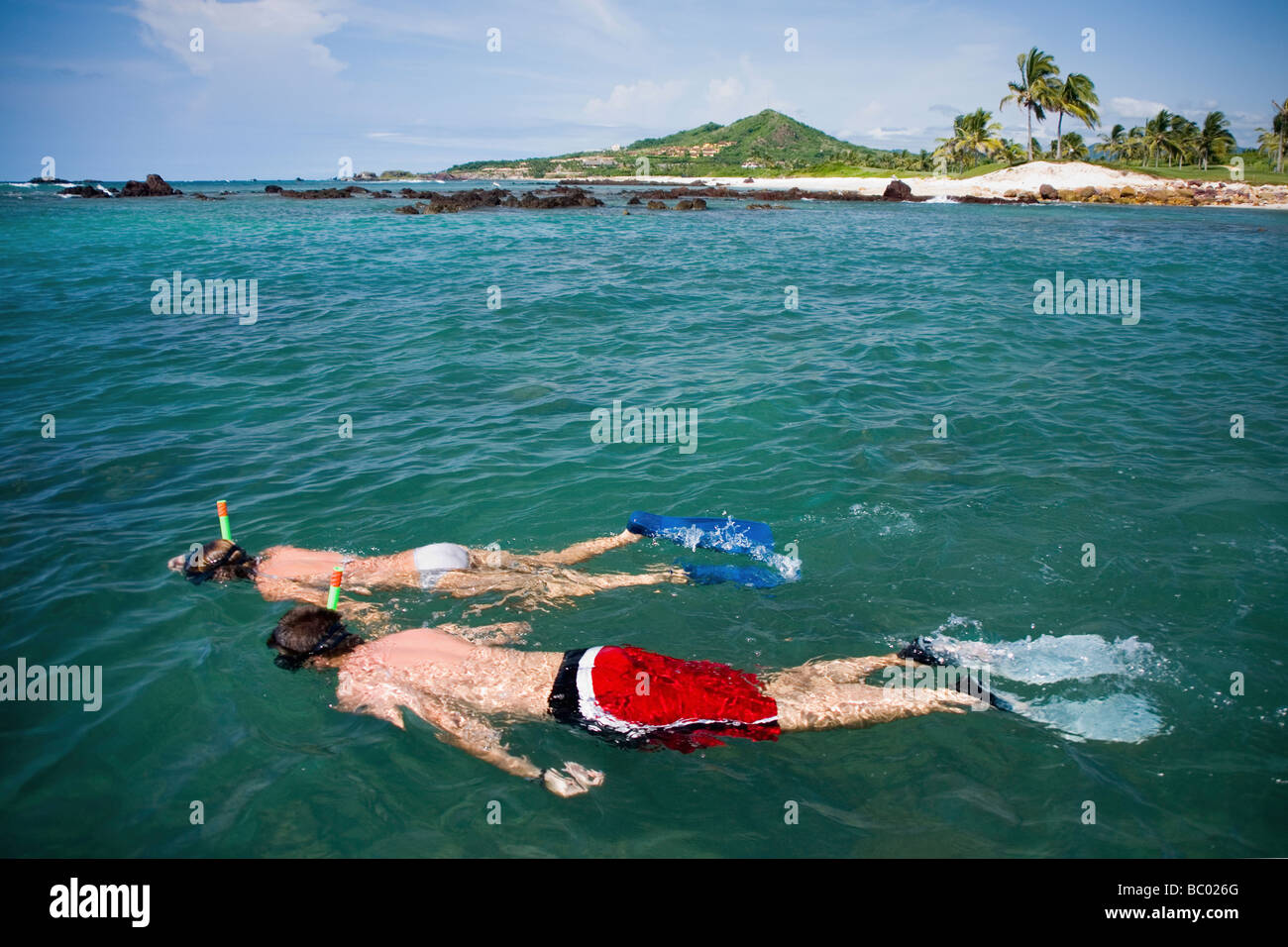 Couple snorkeling in tropical water. Stock Photo