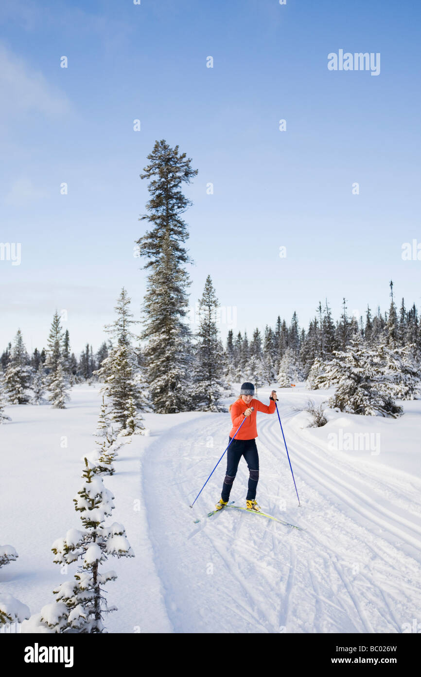 A young woman cross-country skiing. Stock Photo