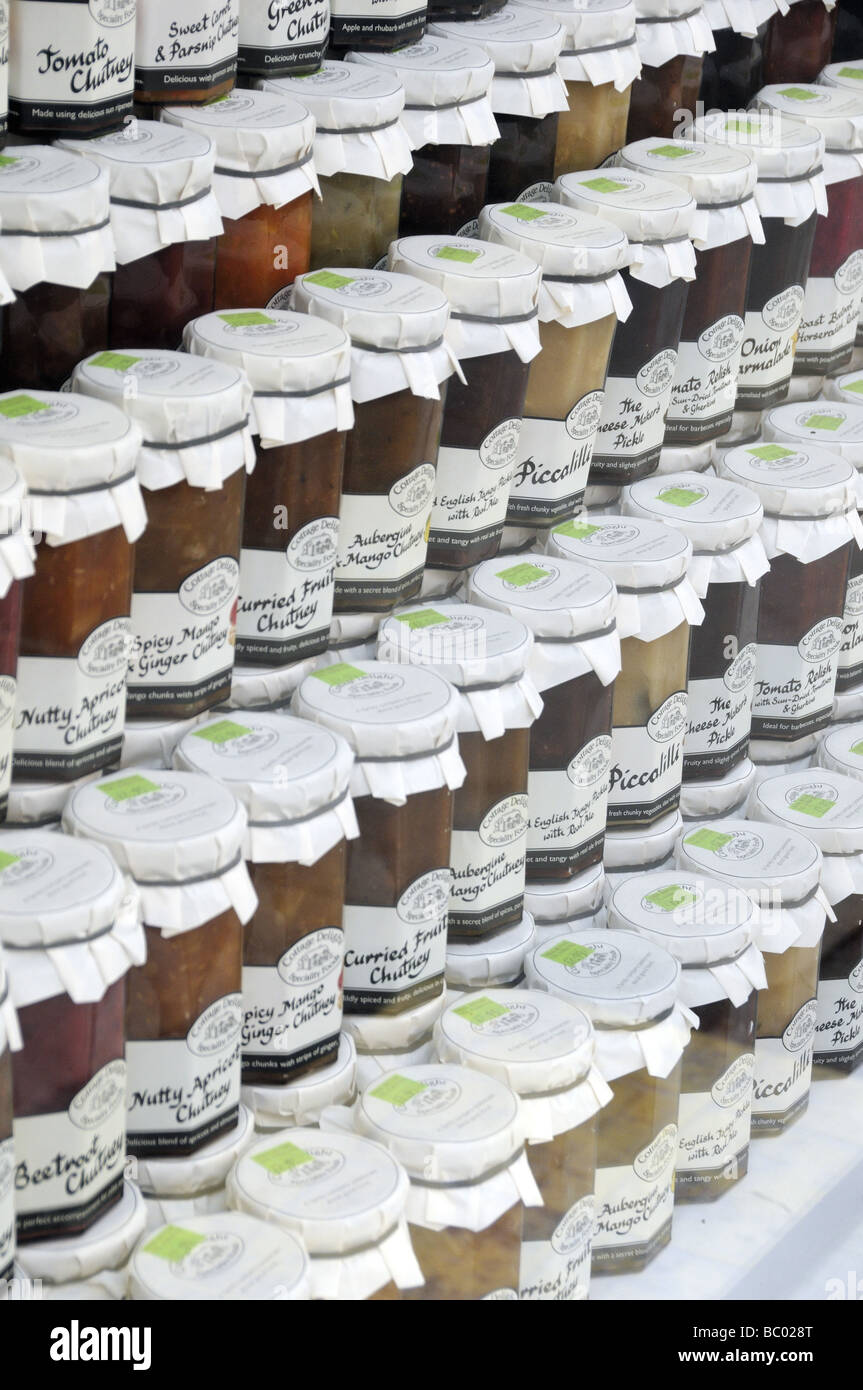 Rows of jars of chutney and pickle on show in shop window Stock Photo