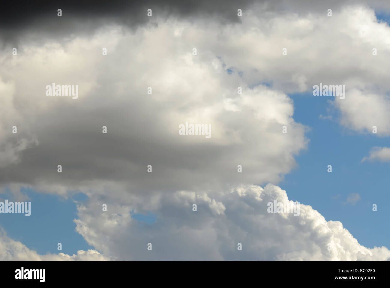 Blue sky with black and white clouds on it Stock Photo - Alamy