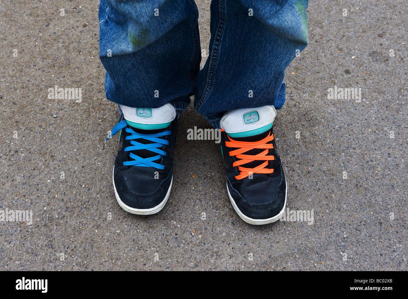 A person wearing trainers shoes with different coloured laces.  Photo by Gordon Scammell Stock Photo