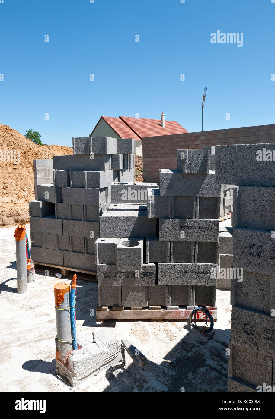 Stacks of breeze block building materials on new housing estate ...