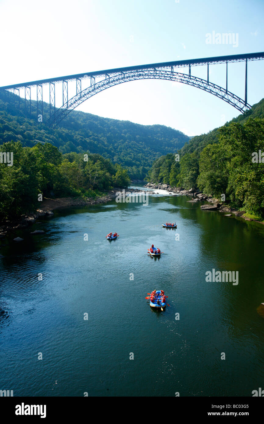 Whitewater rafters float below the New River Gorge bridge. Stock Photo