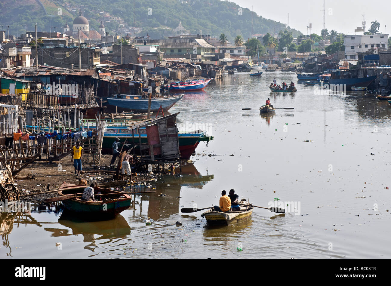 Boaters Make Their Way Along The River Of Cap Haitien Haiti Stock Photo Alamy