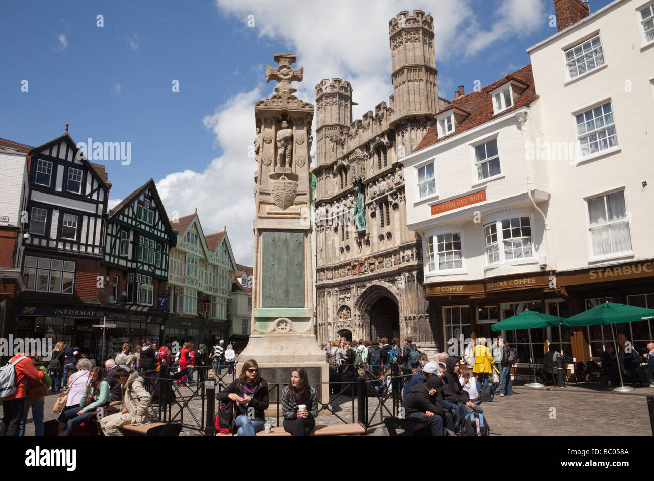 Canterbury Kent England UK Buttermarket Square war memorial and Christ Church Gate busy with tourists in historic city centre Stock Photo