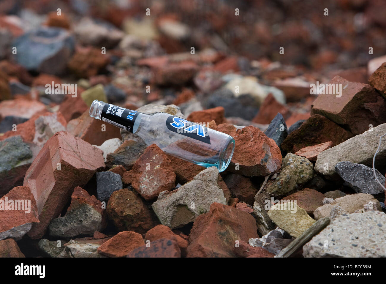 A discarded bottle on a demolished building site Stock Photo