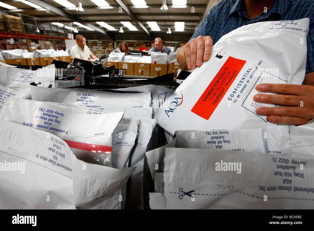 A level exam results are sorted into boxes at the AQA depot in Guildford before being sent across the country to exam centres Stock Photo