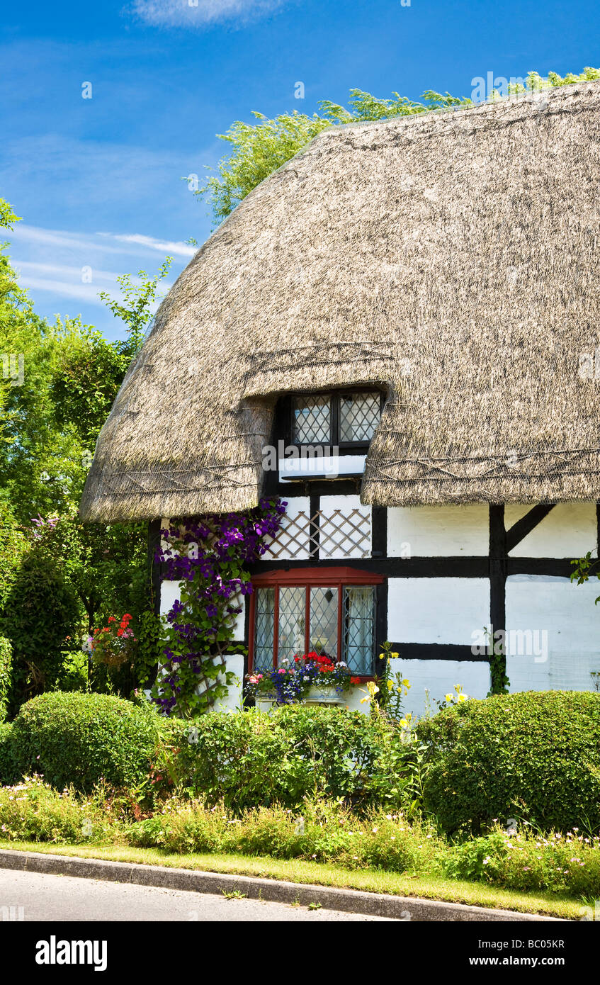 A pretty thatched cottage in a typical English village in Wiltshire England Great Britain UK Stock Photo