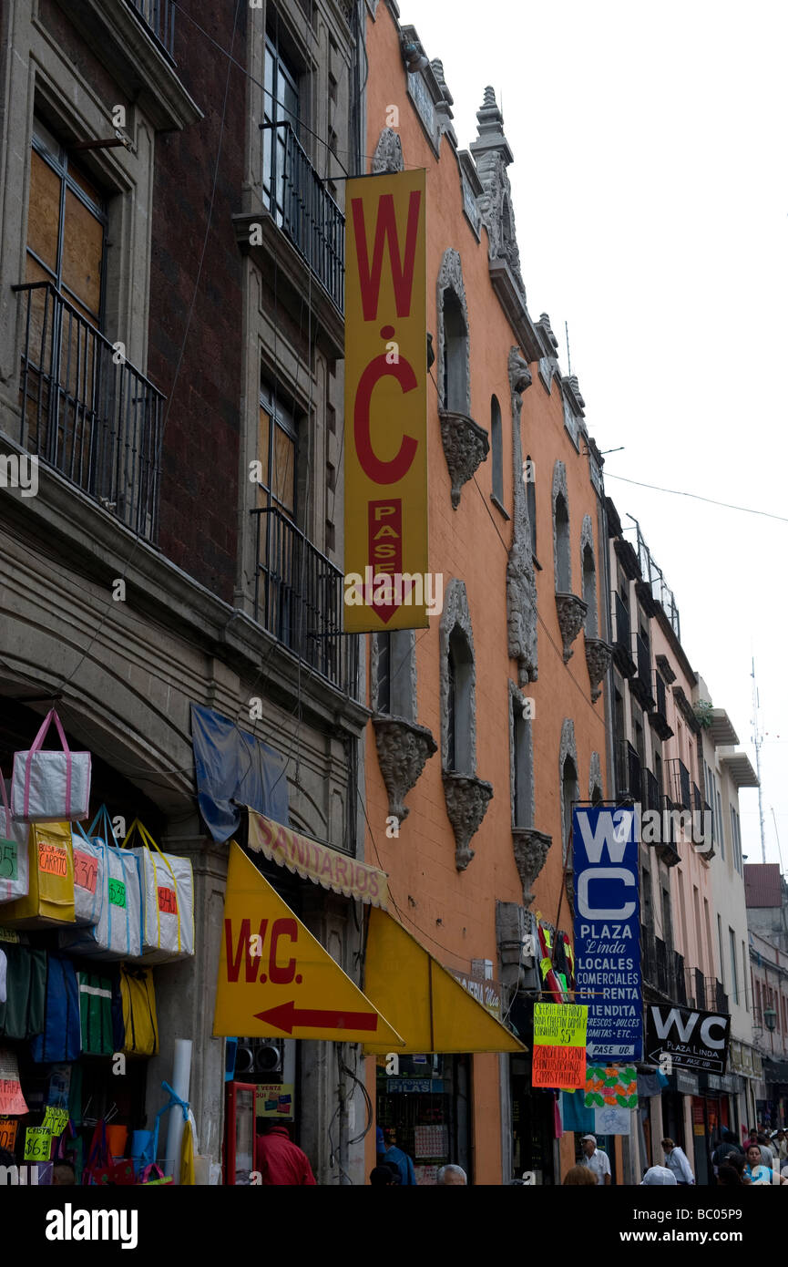Signs pointing to public WCs are common in Mexico City Stock Photo