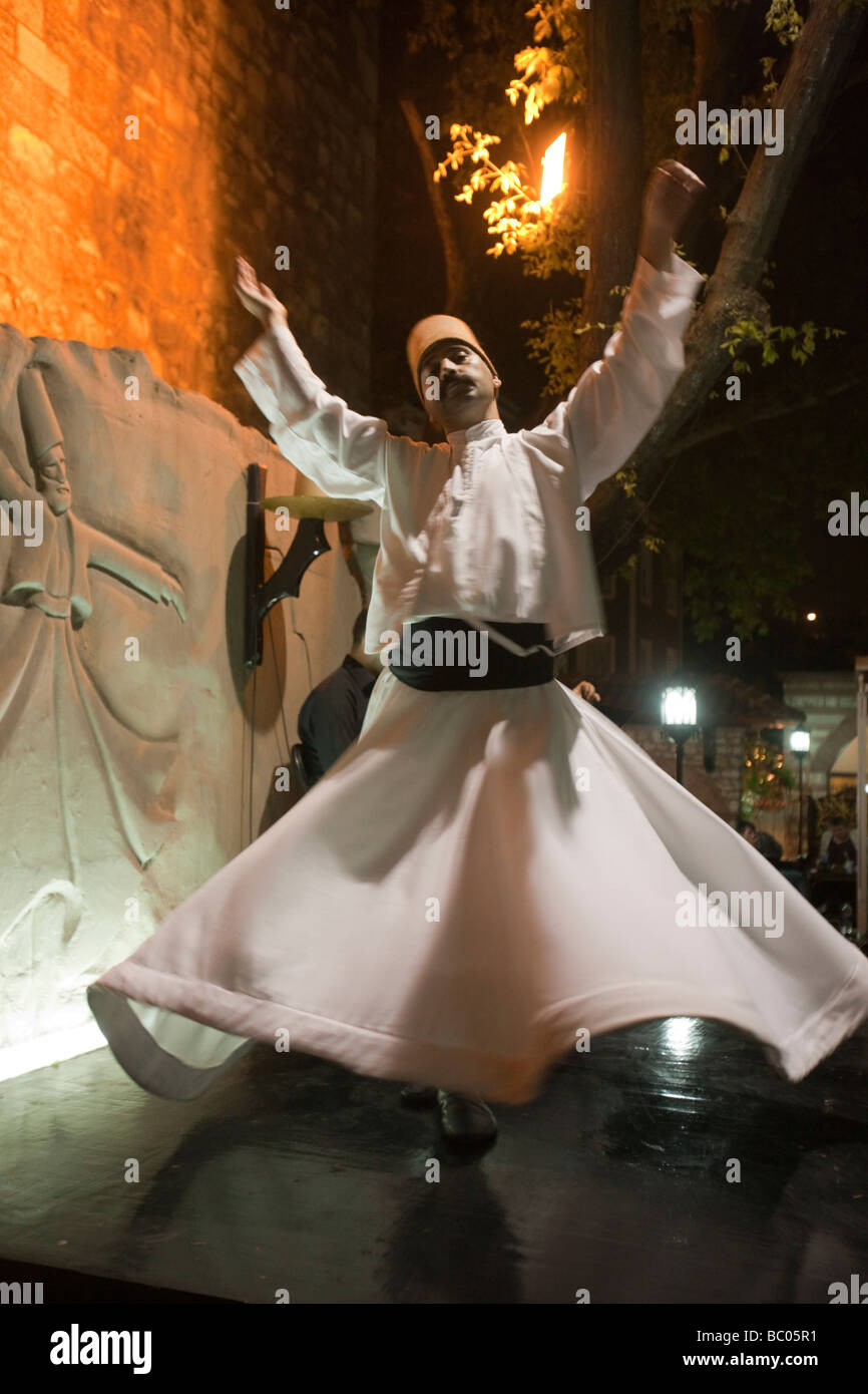 Sufi Derwish dancer in Istanbul dancing his typical spinning dance that brings him in a trance Stock Photo