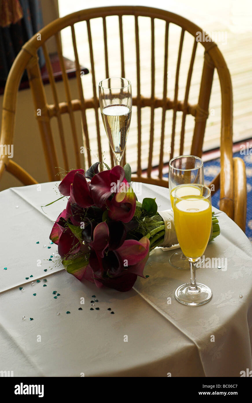 Wine glasses and bouquet on table. Stock Photo