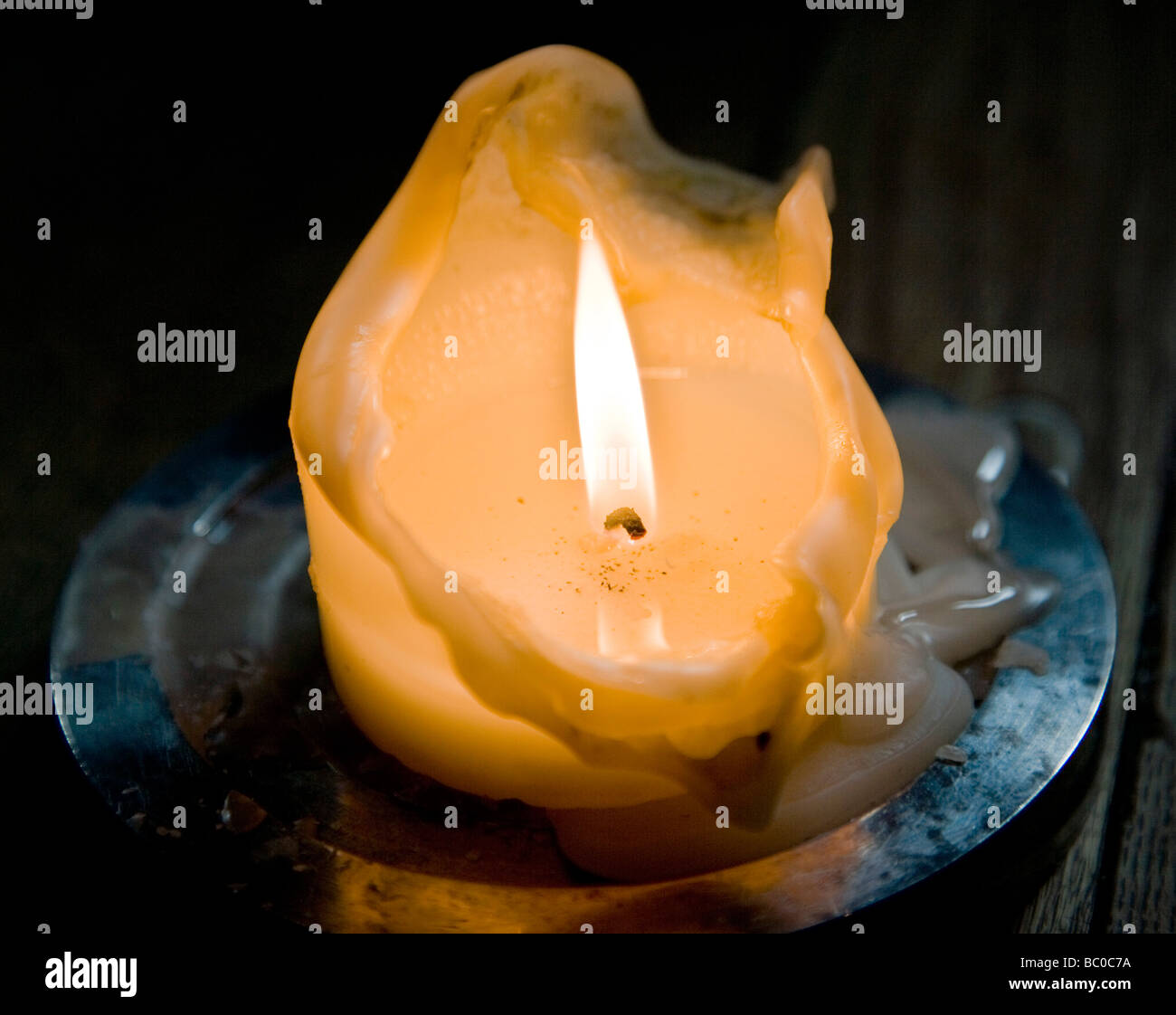 Candle Burning in Subdued Light Stock Photo