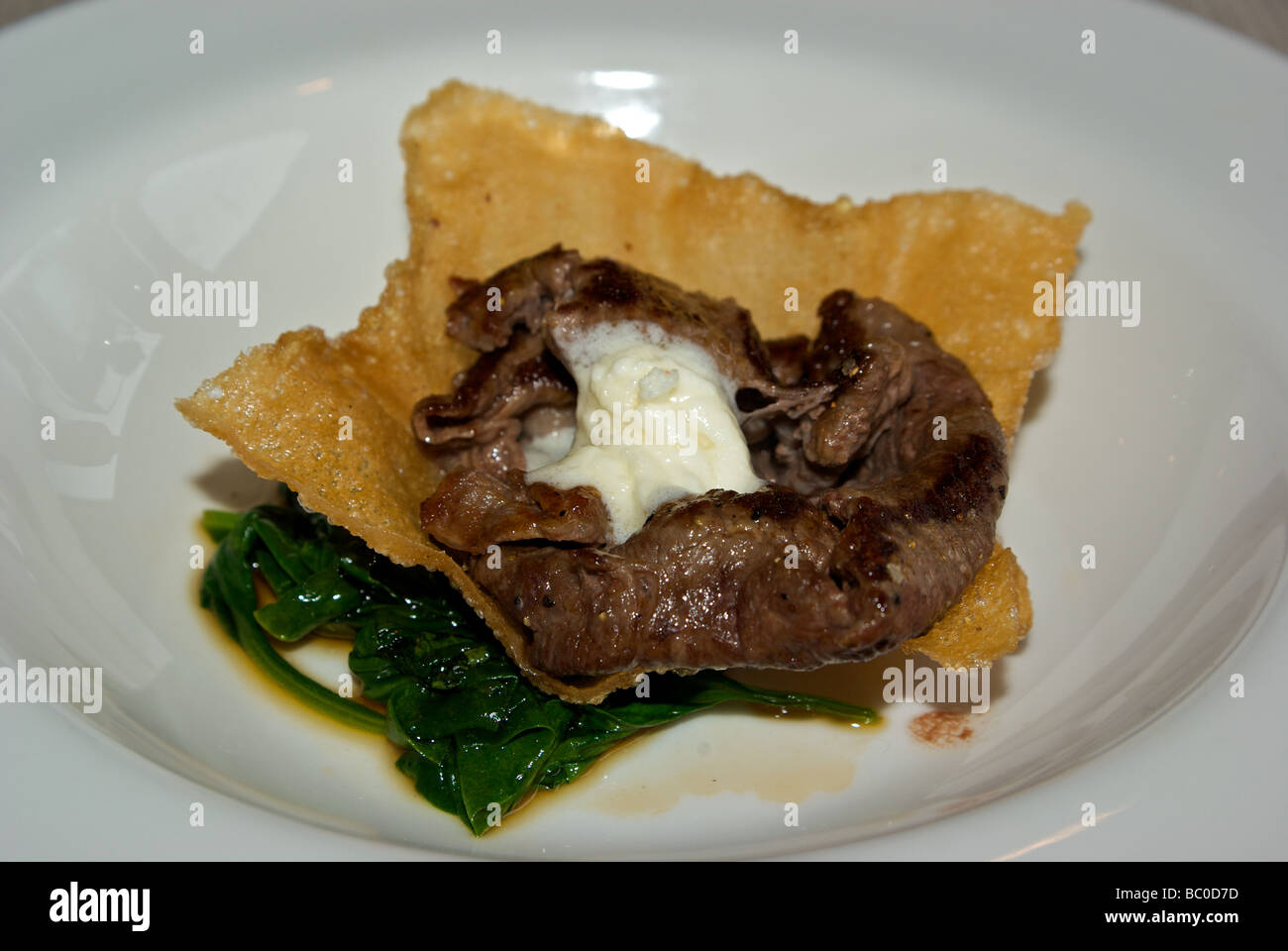 Grilled Kobe beef cheddar cheese mousse foam on deep fried wonton chip