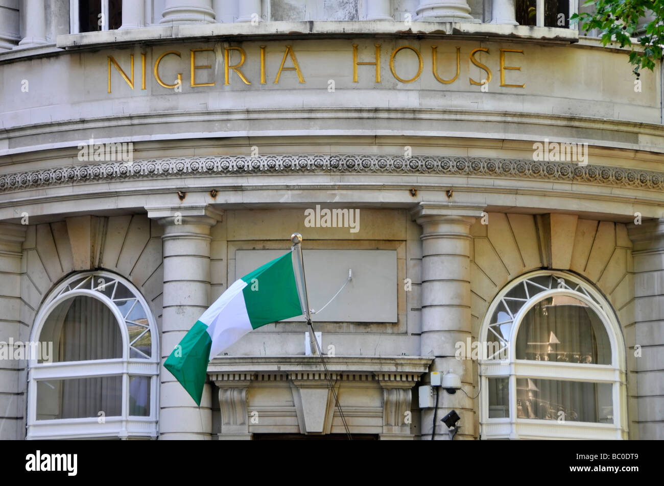 Close up of Nigeria House sign with National flag flying at The Nigeria High Commission London England UK Stock Photo