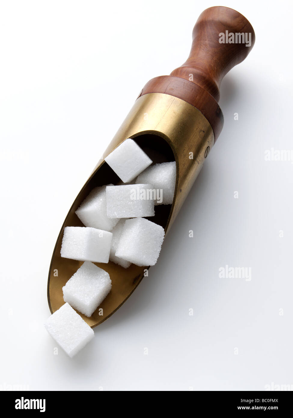 An antique scoop of sugar lumps Stock Photo Alamy