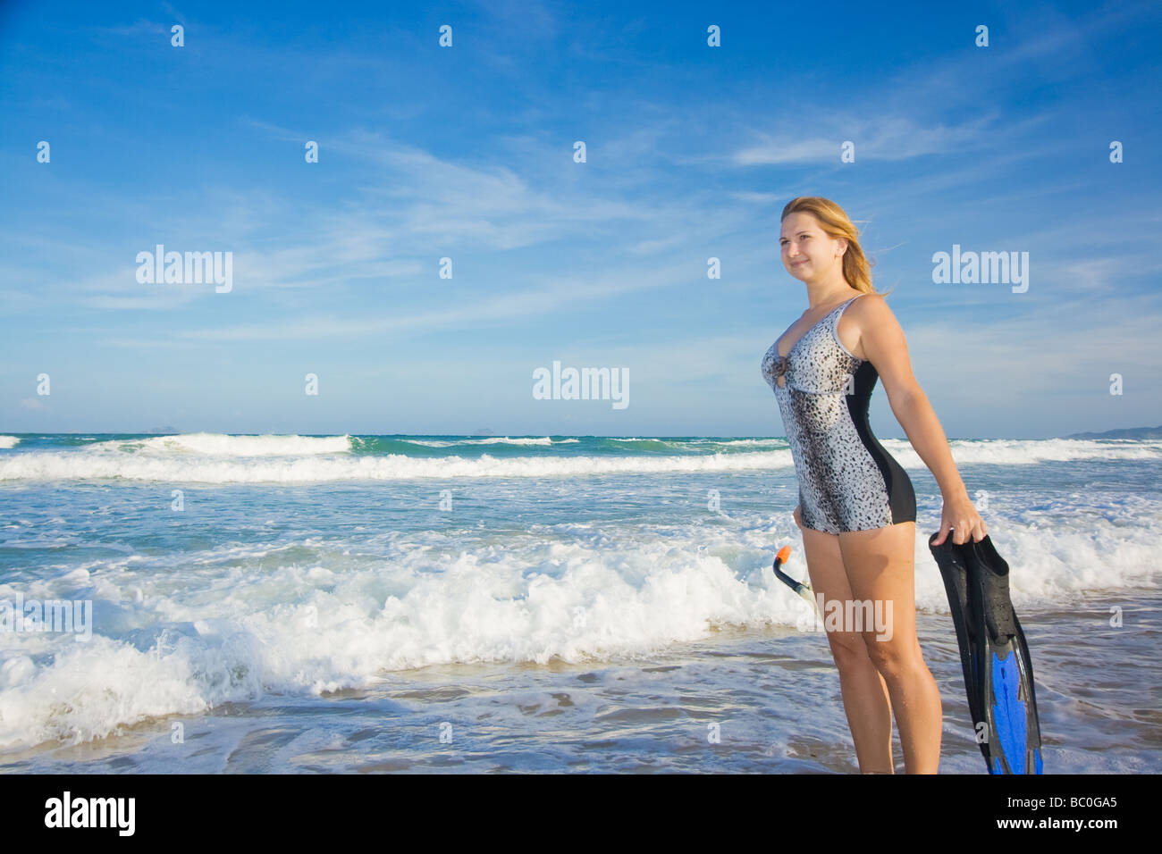 Young woman with snorkeling equipment near ocean Stock Photo