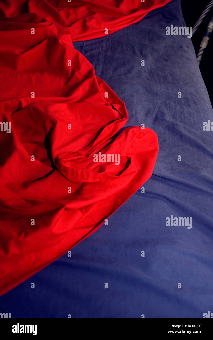 red and blue sheets on bed Stock Photo Alamy