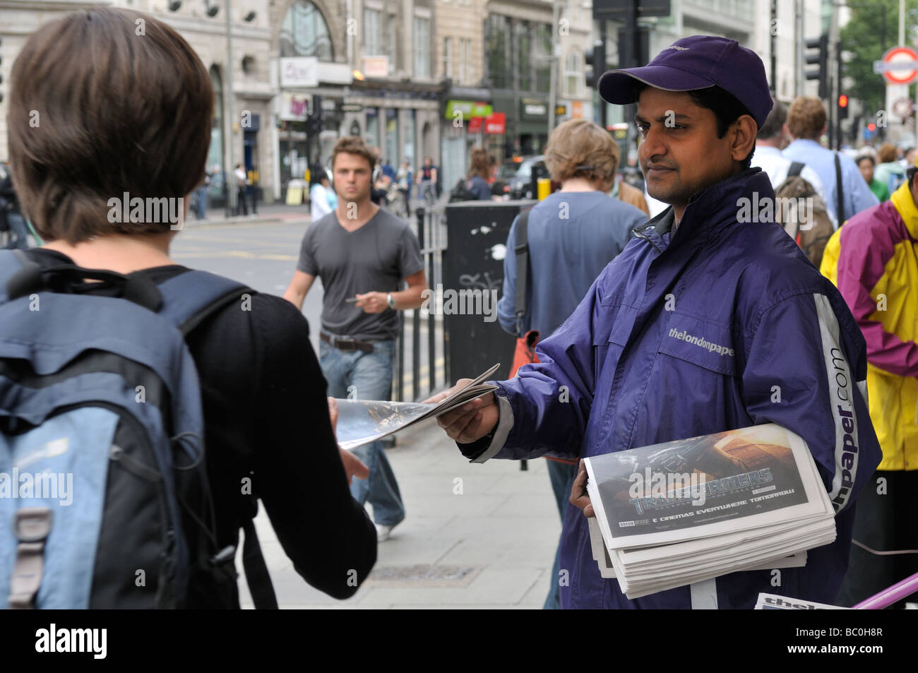 London newspaper vendor distributing free newspapers on High Holborn