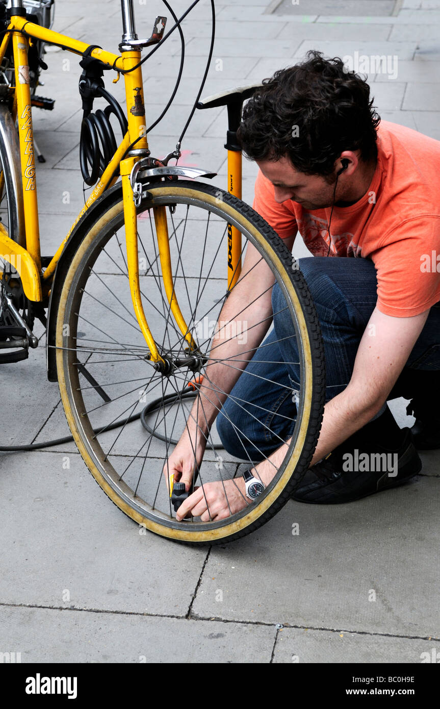 Putting air in bicycle tyre Stock Photo