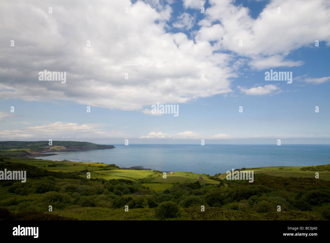 Cliff top view looking across to Robin Hoods Bay from Ravenscar North Yorkshire England Stock Photo