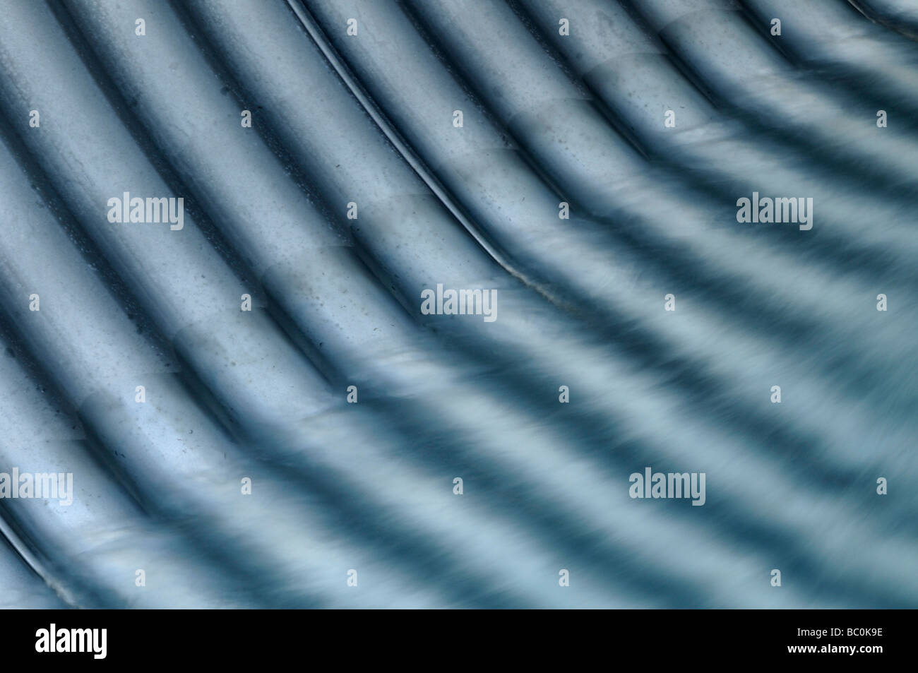 Water flowing through corrugated metal drainage pipe Stock Photo